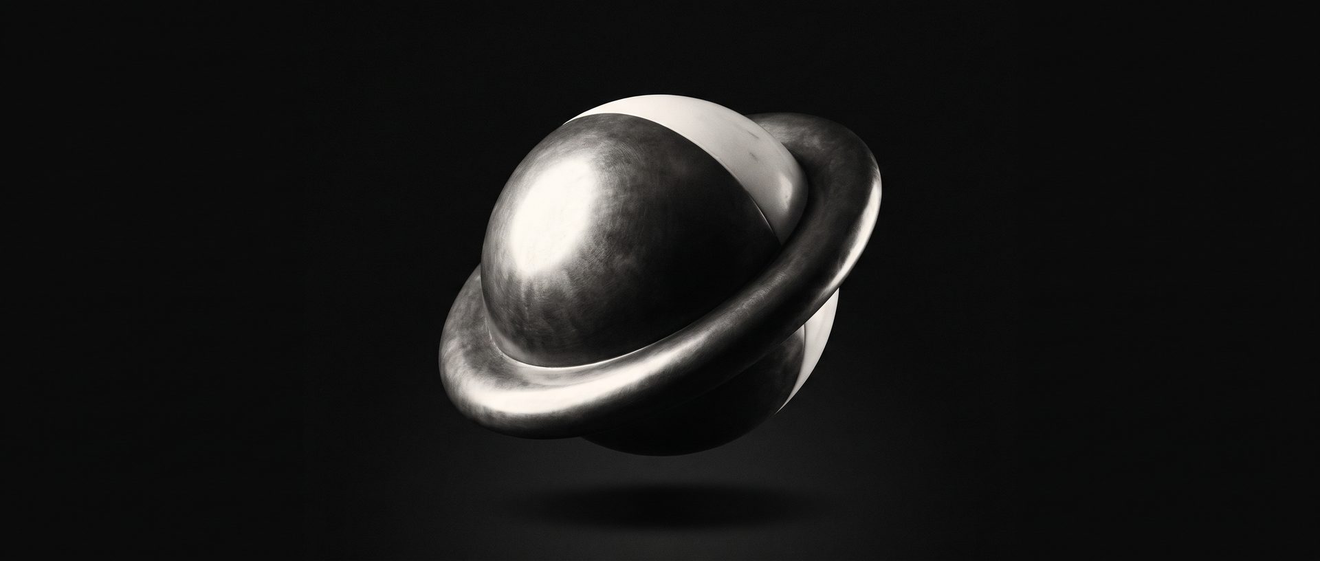 A pale stone sphere set inside a matching stone ring, resting on a low plinth against black.